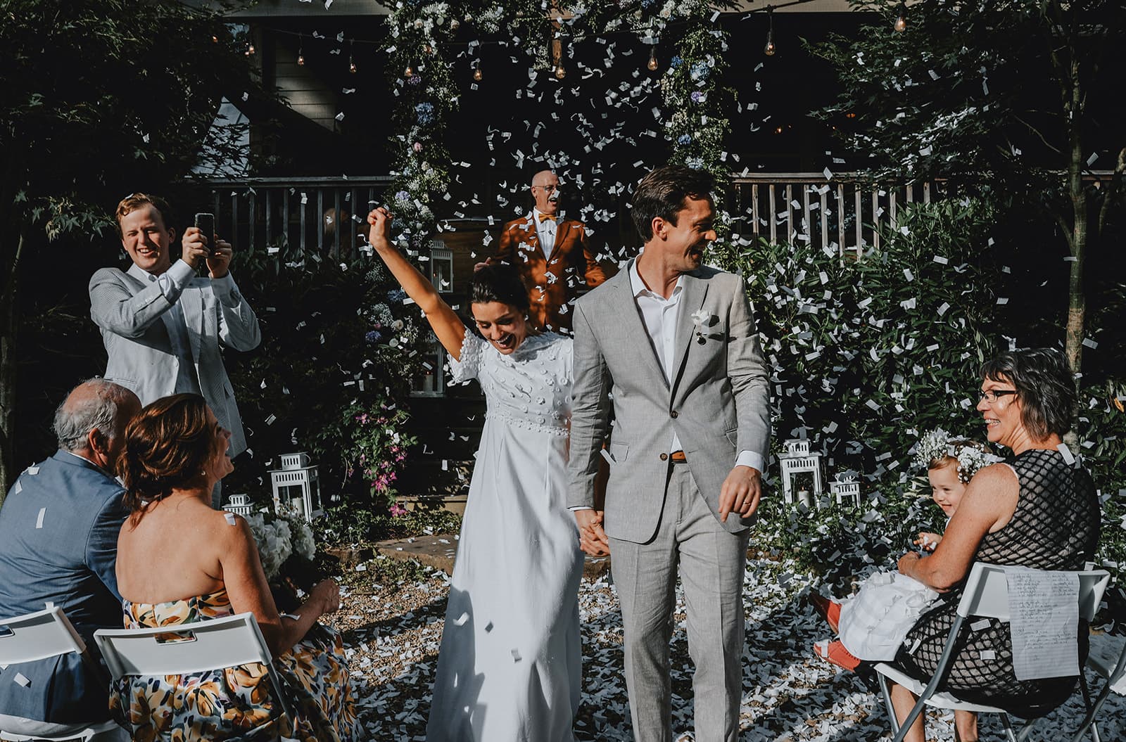 translucent vases with white flowers adorn a wedding reception table
