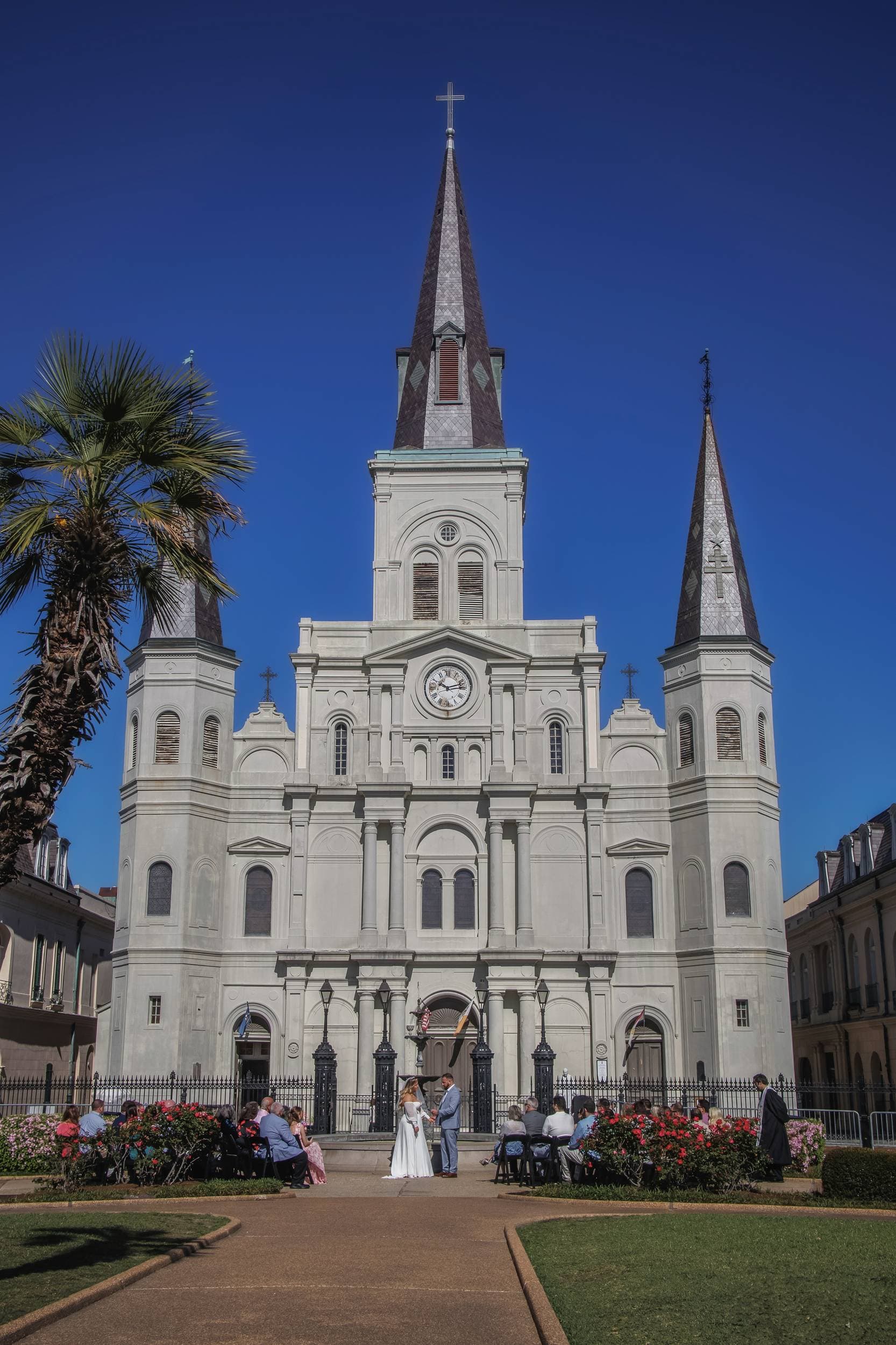 groom holds bride as she tips her head back and laughs